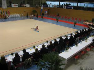 The row of tables closest to the performance area is where the judges were located.  The second row of tables is where the scores were tabulated.  There were young runners which would take the score sheet from the judges to the scoring tables.