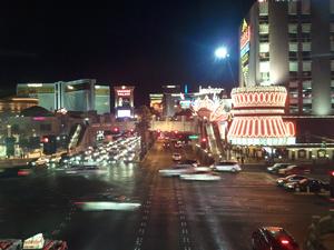 This picture was taken from a pedestrian bridge over Las Vegas BL (The Strip).  It is looking toward the North.  The brightly lite building on the right is the Flamingo.  On the left is Cesar's Palace, however you cannot see much of it.  The tall building on the left at about the middle of the picture is the Mirage.
