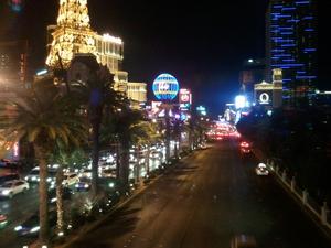 I was standing on a pedestrian bridge over Las Vegas BL looking South.  On the left, you can see the minature Eiffle tower replica and the large ballon shaped sign.  Both are part of the Paris hotel and casino.  The dark area on the right is the Bellagio hotel and casino.