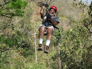 Jeff is arriving at the end of the zip line.