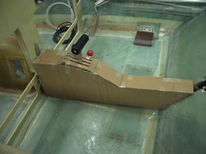 The center console.  This took several months to design and build.  This picture is of the third version of the card board mockups that we made.  The penciled in circle forward of the throttle quadrant is where the cup holder is.