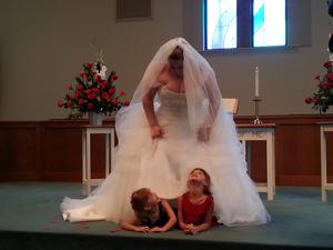 Karen with Shelbea and Reghan under her wedding dress
