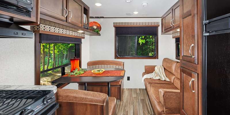 My requirement was to have both a sofa and a dining room table. </p> <p>One neat feature of the living area are the three windows one on each side and the back.  This makes the trailer feel larger than it is.