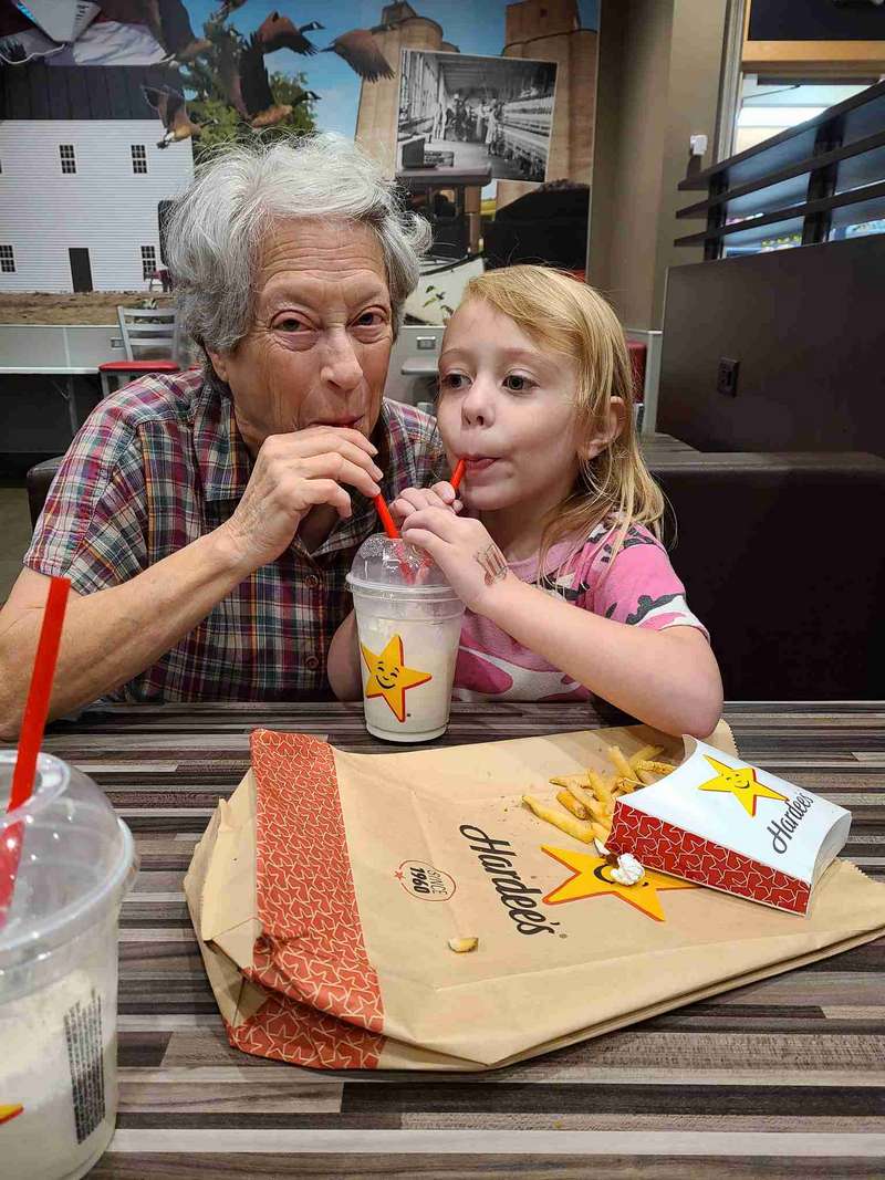Helena and Grandma Helen sharing a shake at a truck stop