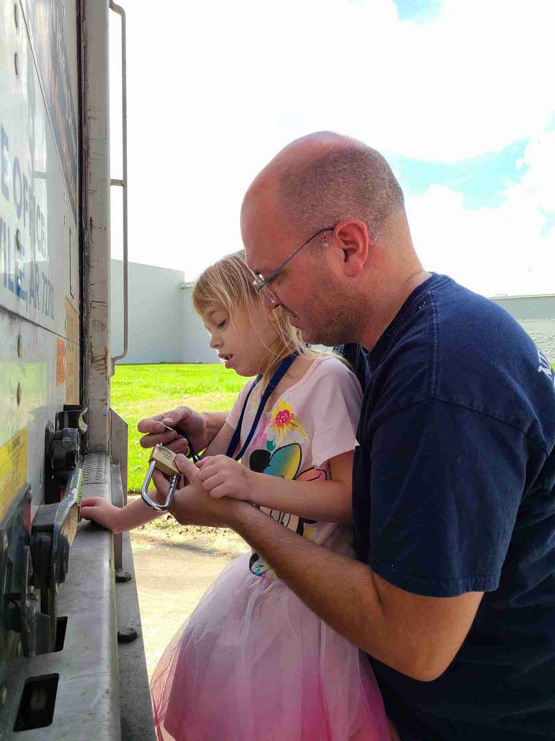Daddy training Helena on how to lock a trailer
