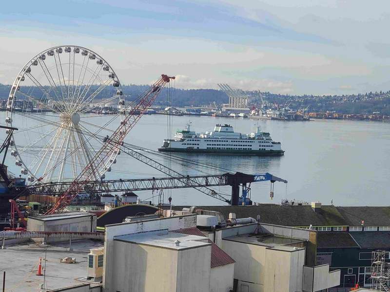 Ferry boat, ferris wheel and lots of cranes overlooking the sound