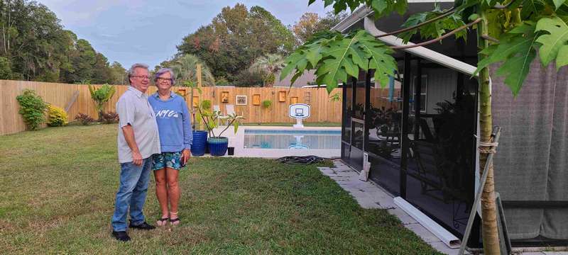 Robert and Jenny in their backyard.  Notice on the fence behind them, Jenny has affixed a lot of boxes.  She highlights various plants through out the year in them.