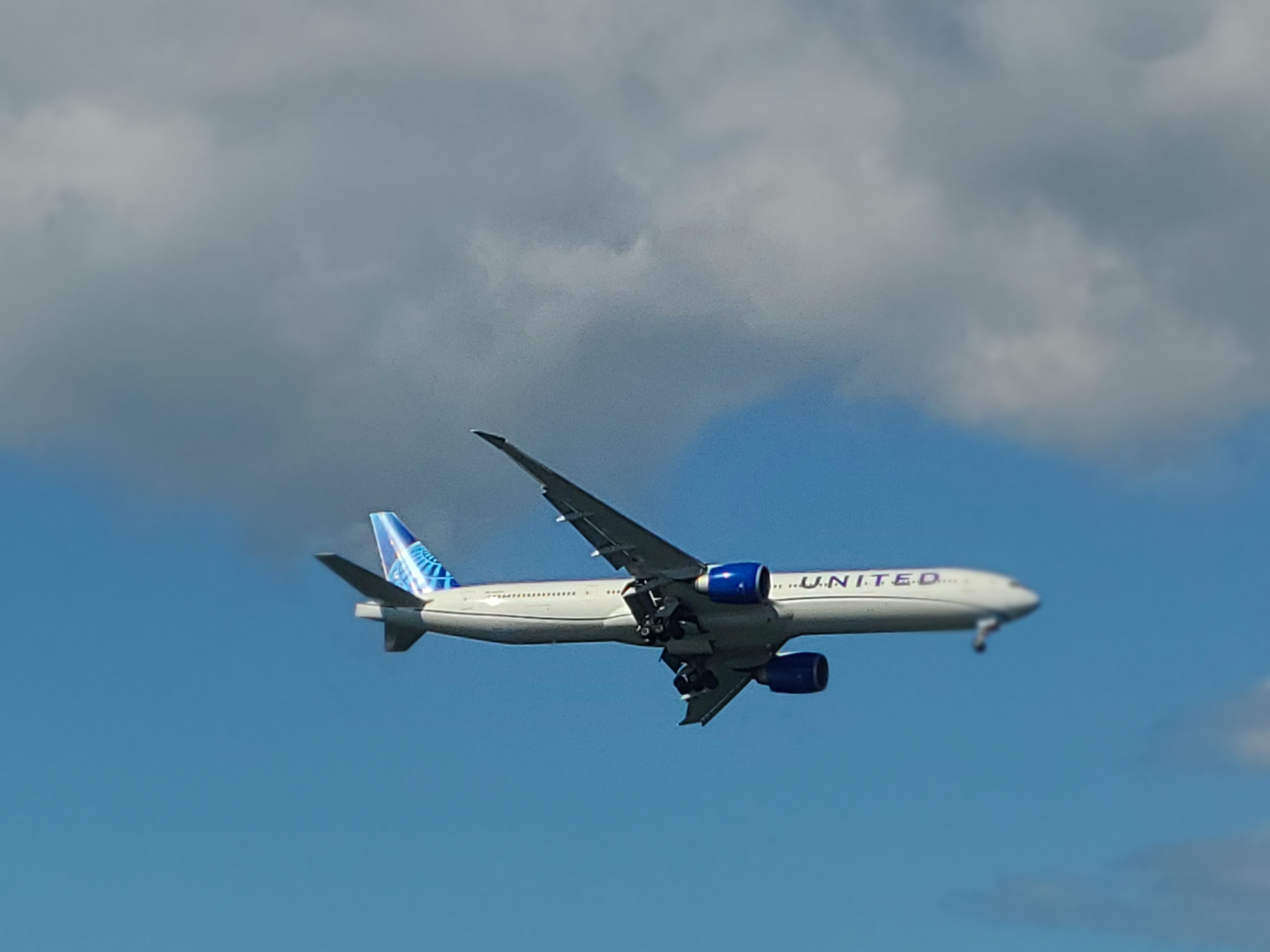 A United 777 doing a low pass flyby.