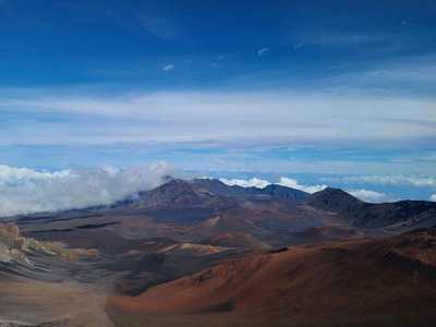 A rare, crystal-clear sunlit view looking down into the massive crater of Haleakalā on Maui.