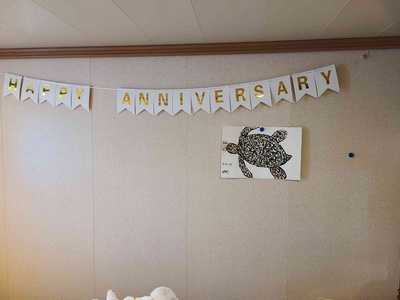 Helen's finished watercolor turtle on display below our anniversary banner.
