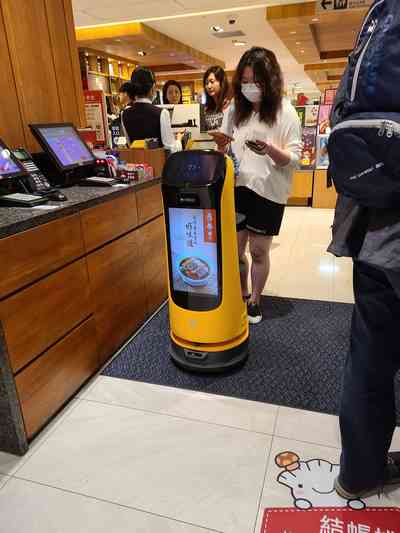 You are led to your table by a robot.
