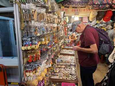 Wayne purchasing curios from a street vendor.