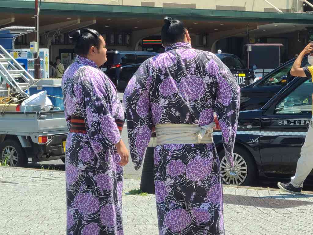 Wrestlers walking past the venue gates.