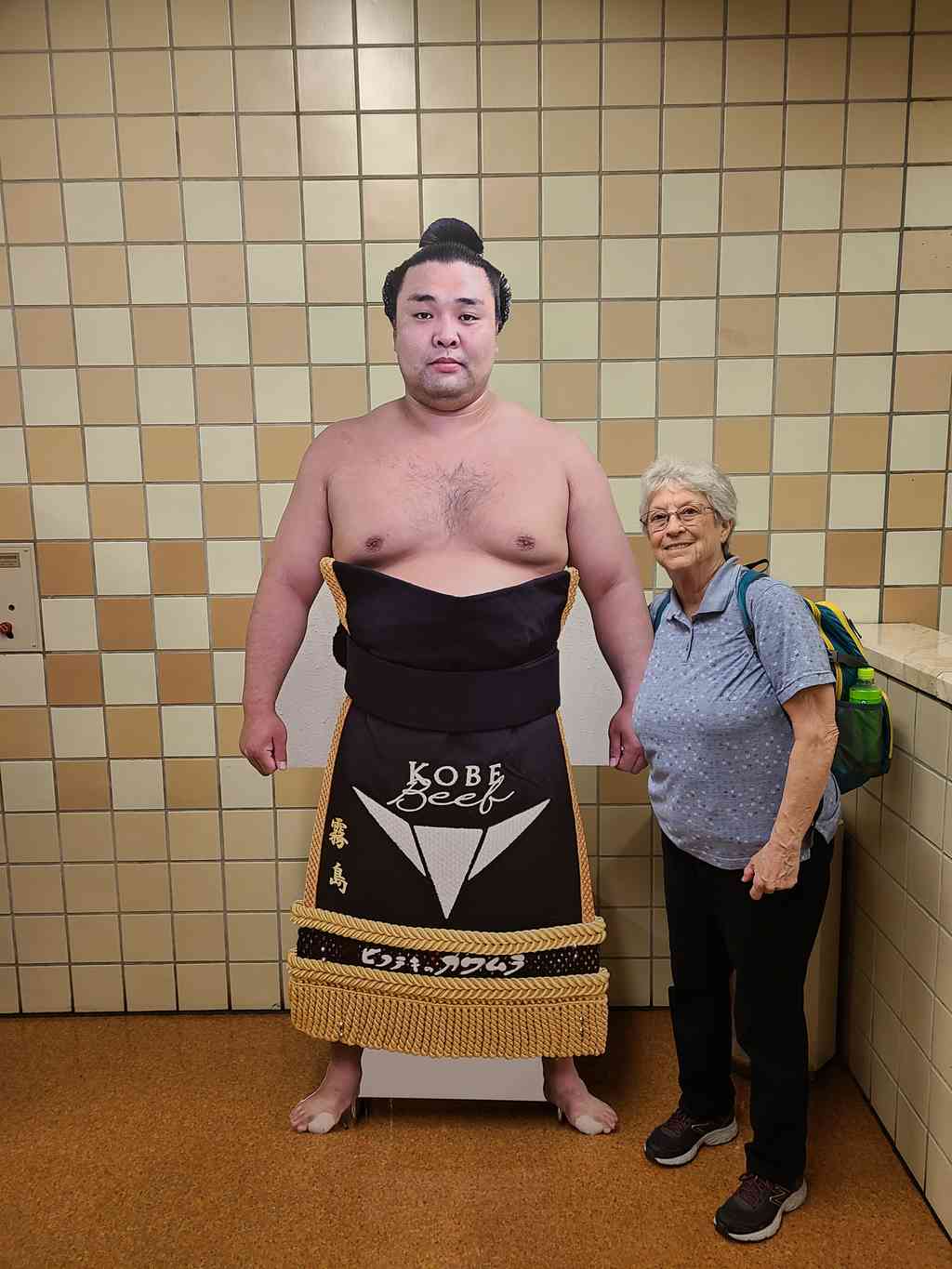 Helen comparing heights with a sumo wrestler cutout.