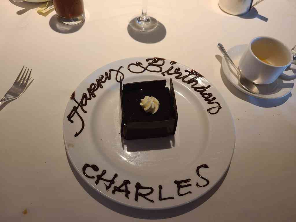 Surprise birthday cake celebration for Charles during a relaxing sea day.