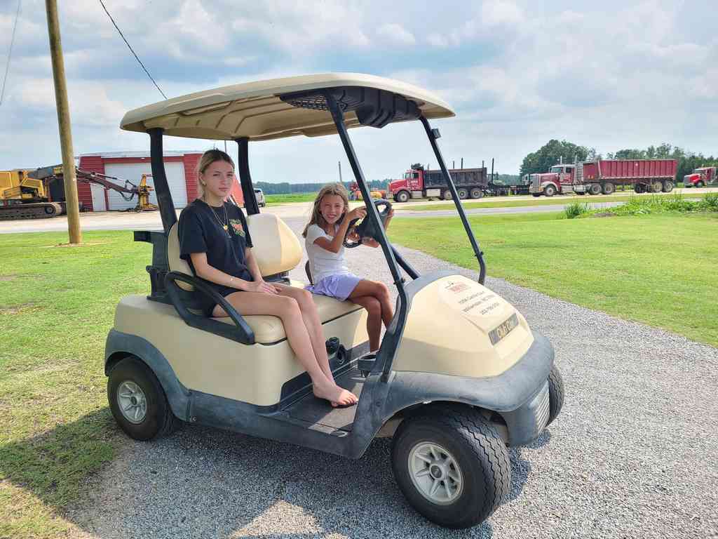 Reghan and Ann Marie cruising fast on the golf cart.