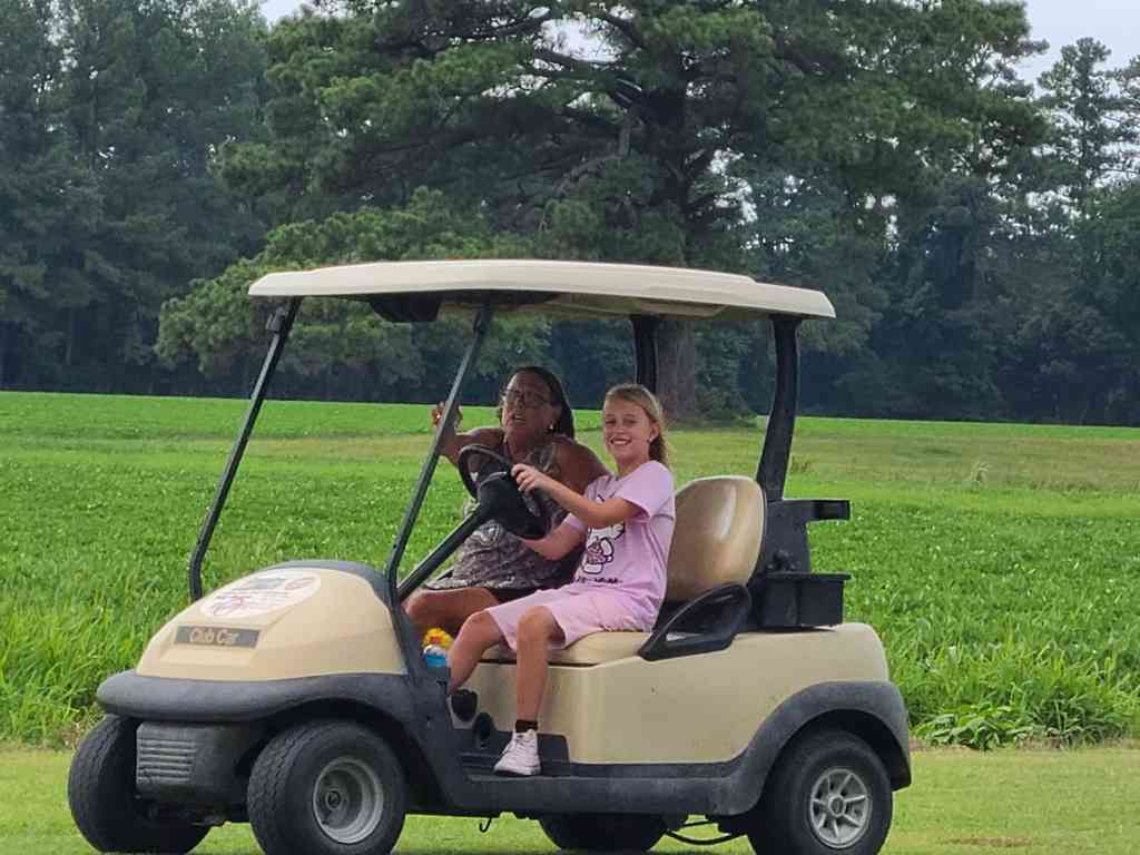 Helena taking driving lessons from Cousin Rae.